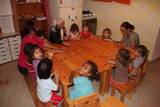 Anne Christine joins the younger group at work around the table
